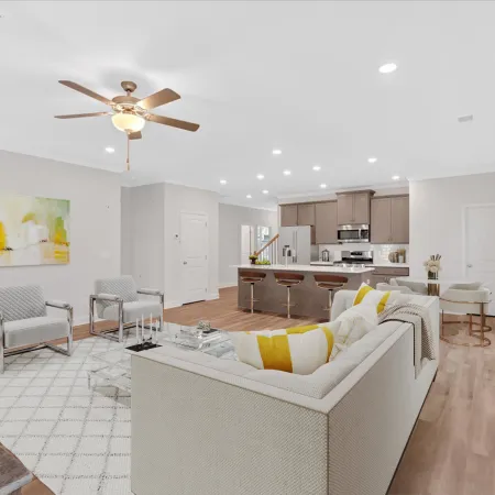 Bright, modern living room with stylish furniture and open kitchen layout.