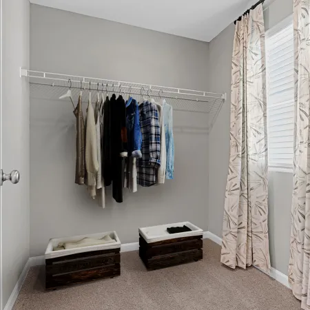 a room with a bed and a dresser