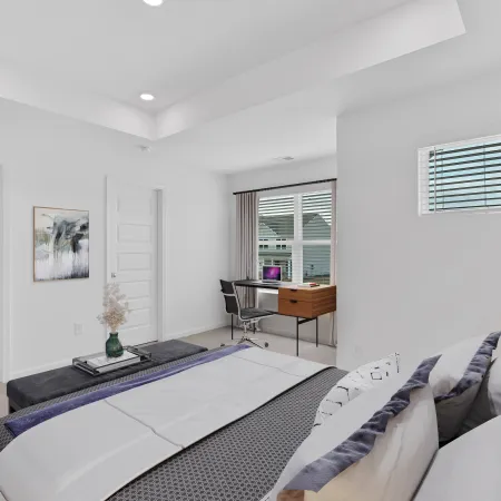 Bright modern bedroom with large window, desk, and cozy decor for a serene atmosphere.