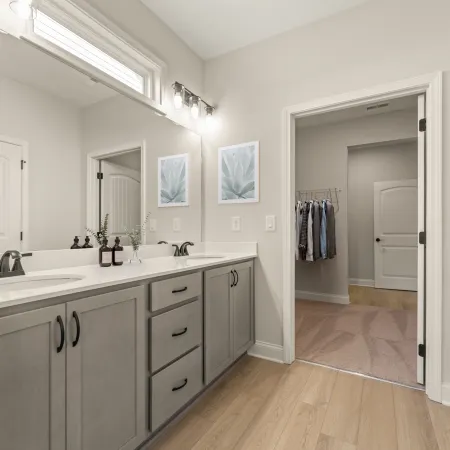 a bathroom with white cabinets