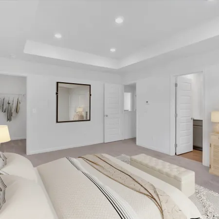 Modern, bright bedroom featuring a cozy bed, decorative mirror, and stylish furnishings.
