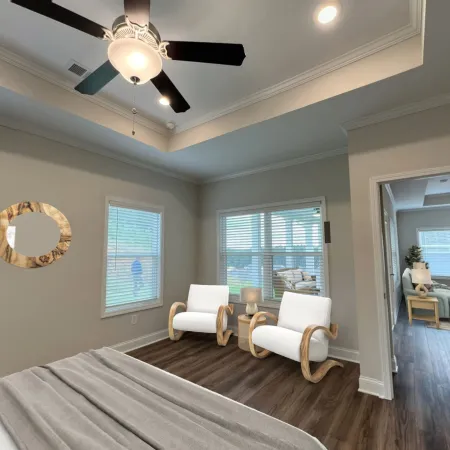 a bedroom with a bed and a fan