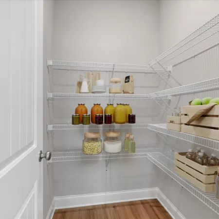 Organized pantry with wire shelves holding jars, bottles, wooden crates with green apples, and dry goods.