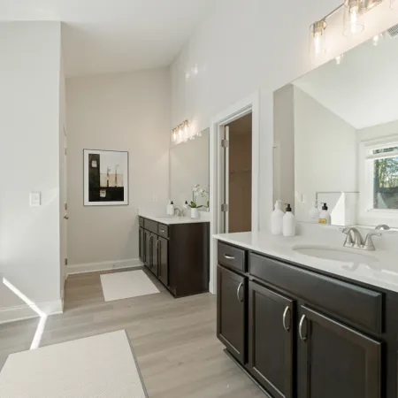 a bathroom with a tub sink and cabinets