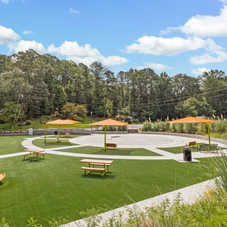 a park with benches and umbrellas