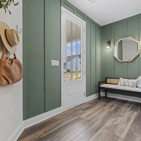 a room with a bench and a mirror