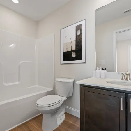 a bathroom with a tub sink and toilet