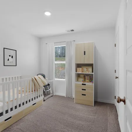 Cozy nursery featuring a crib, wooden storage unit, and soft decor in a bright, calming space.