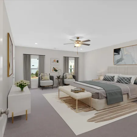 Spacious modern bedroom with neutral decor, comfortable furnishings, and natural light.