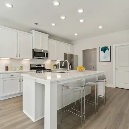a kitchen with white cabinets