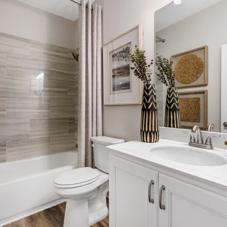 a bathroom with a tub sink and toilet