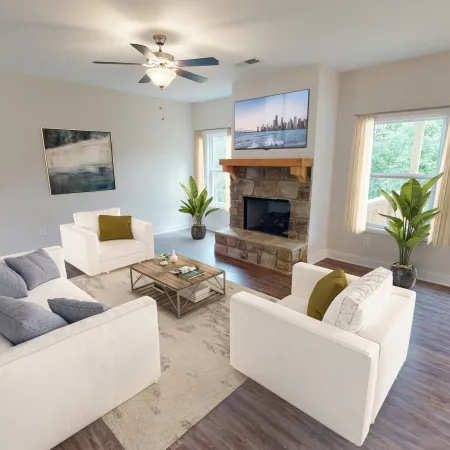 a living room filled with furniture and a flat screen tv
