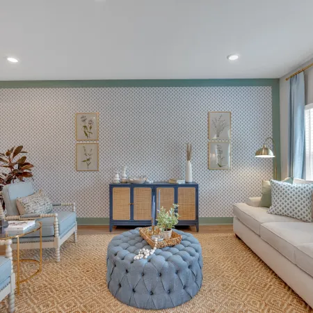 Bright, modern living room with blue accents, plush seating, and stylish decor elements.