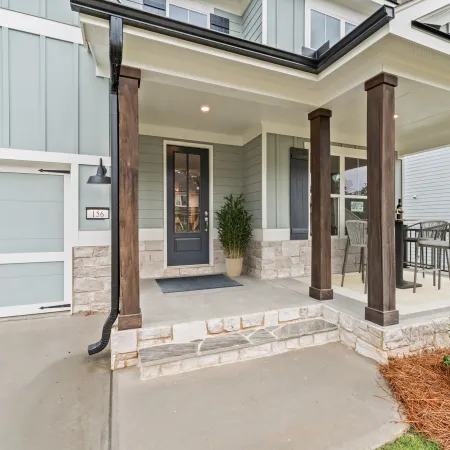 a building with a patio and a patio with a table and chairs