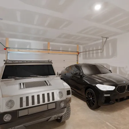 A modern garage showcasing two luxury SUVs parked side by side in elegant neutral tones.