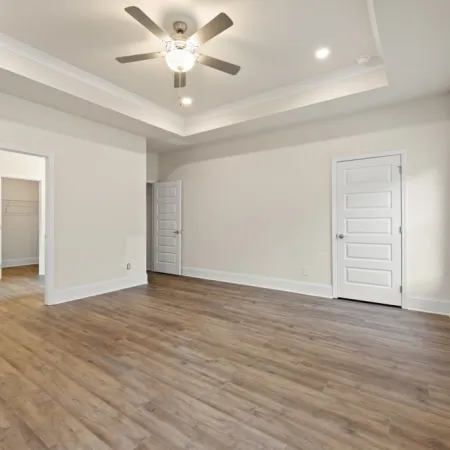 a room with a wood floor and a ceiling fan