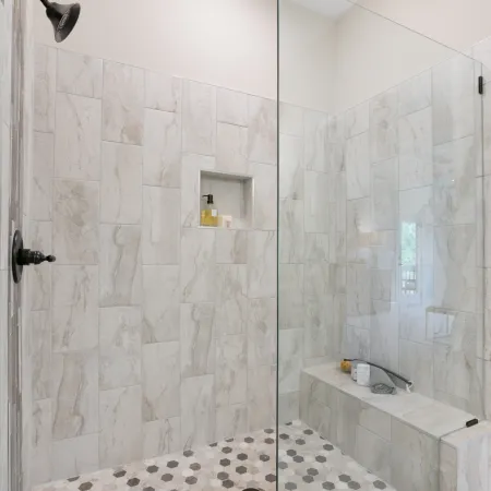 a bathroom with a shower unit and a sink