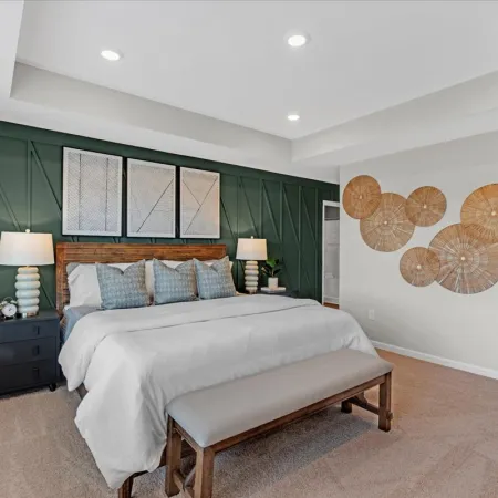 a bedroom with a bed and a bench