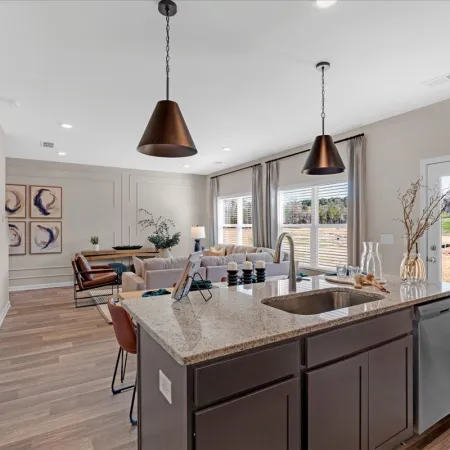 Modern kitchen and living area with stylish decor and outdoor view in a home interior.
