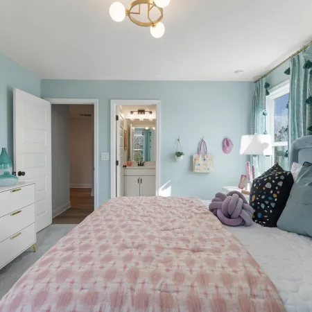 a bedroom with a bed and a mirror