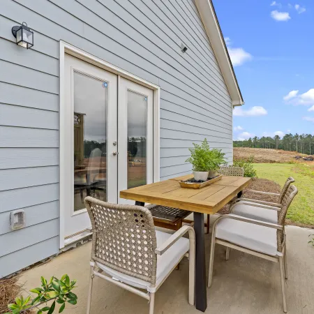 a table and chairs outside a house