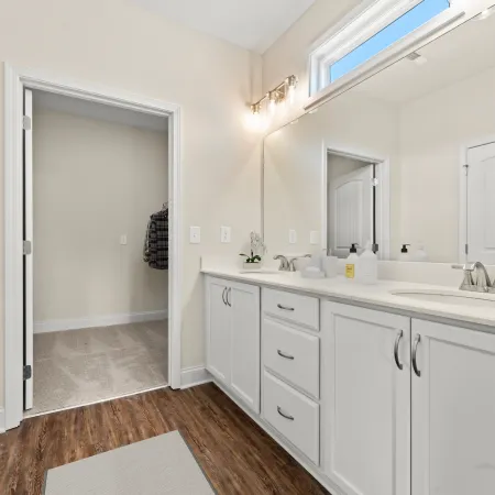 a bathroom with white cabinets