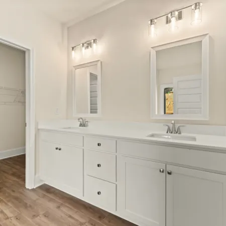 a bathroom with white cabinets