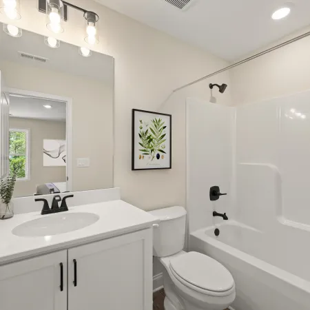 a bathroom with a tub sink and toilet