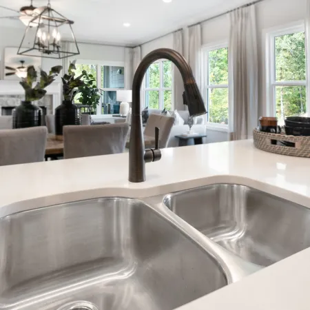 a kitchen with a sink and a white tub sitting next to a window