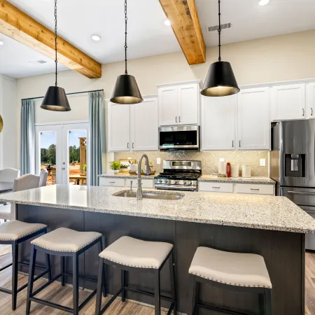 a kitchen with a bar stool and a table