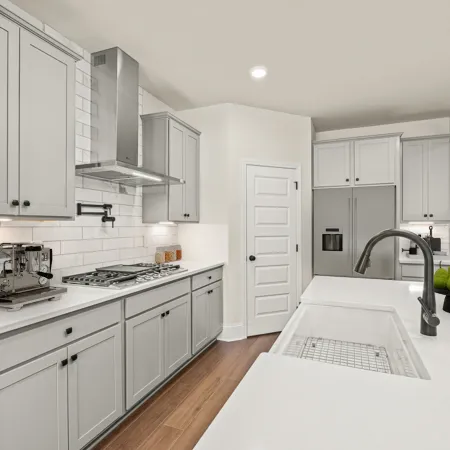 a kitchen with white cabinets