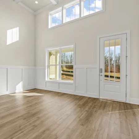 a room with white walls and windows