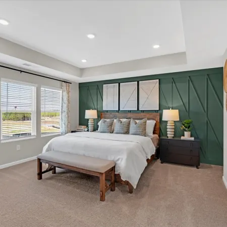 a bedroom with a bed and a bench