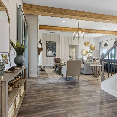 a living room with a chandelier and a dining table