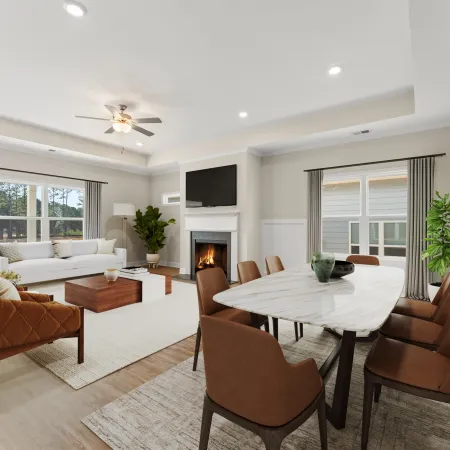 a living room with a table and chairs