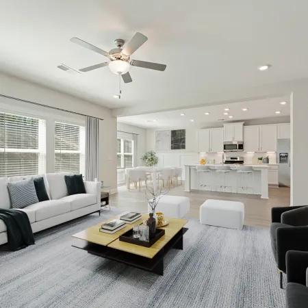 a living room with a large ceiling fan and a couch