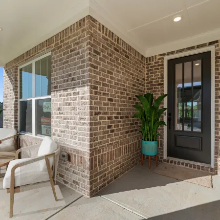 a brick house with a patio and a table and chairs