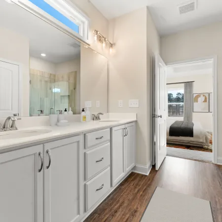 a bathroom with white cabinets