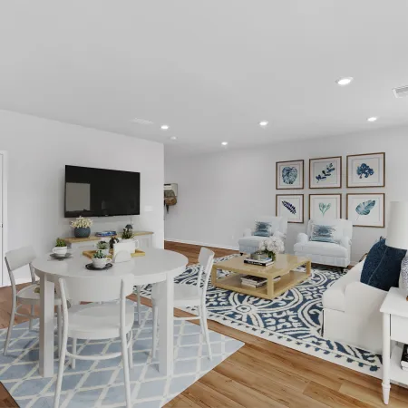Modern living room and dining area with light furnishings and decorative rug, bright and inviting atmosphere.