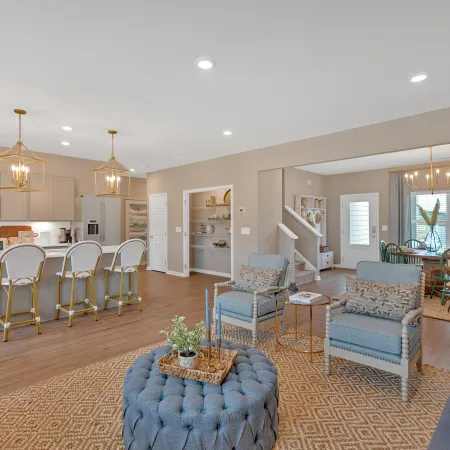 Modern open-concept living room and kitchen with stylish decor and inviting atmosphere.