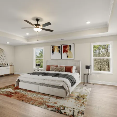 a bedroom with a bed and a fan