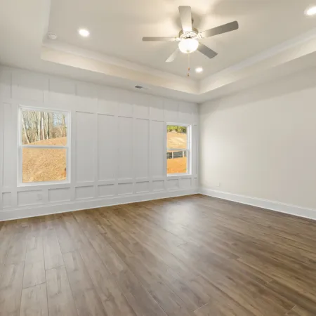 a room with a wood floor and a ceiling fan