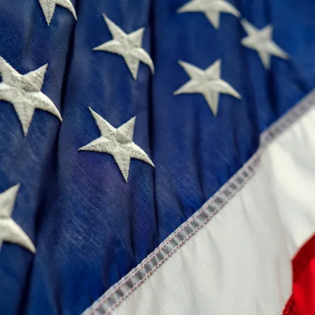 Close-up of the American flag Mortgage Loans for Veterans with Bad Credit in Orlando, FLars on blue and red and white stripes fabric.