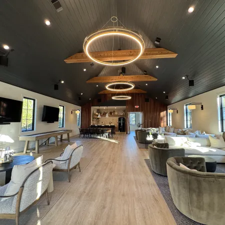 a large room with a wood floor and a large chandelier