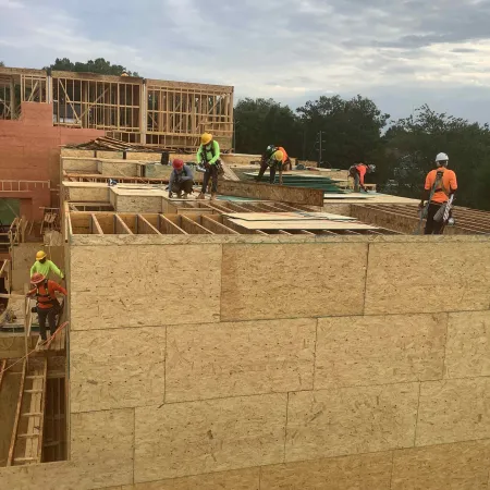 a group of construction workers on a building