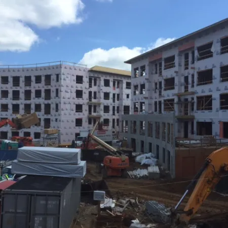 a construction site with cranes and buildings