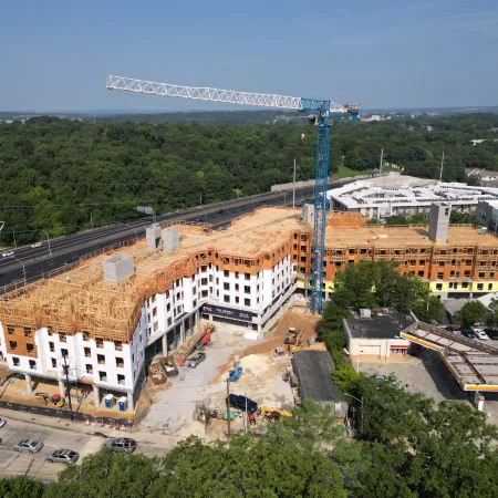 a large building with a bridge in the background