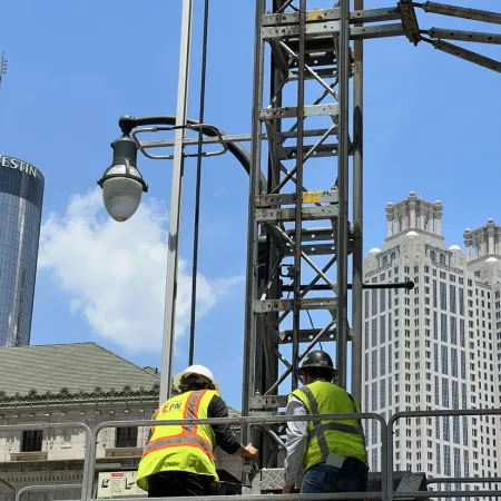 a couple of men in yellow vests on a construction site