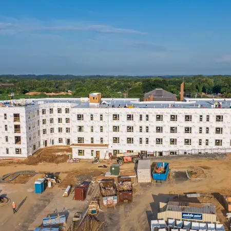 a large white building with a parking lot in front of it