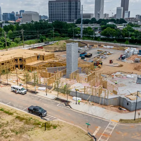 a construction site with cars and buildings